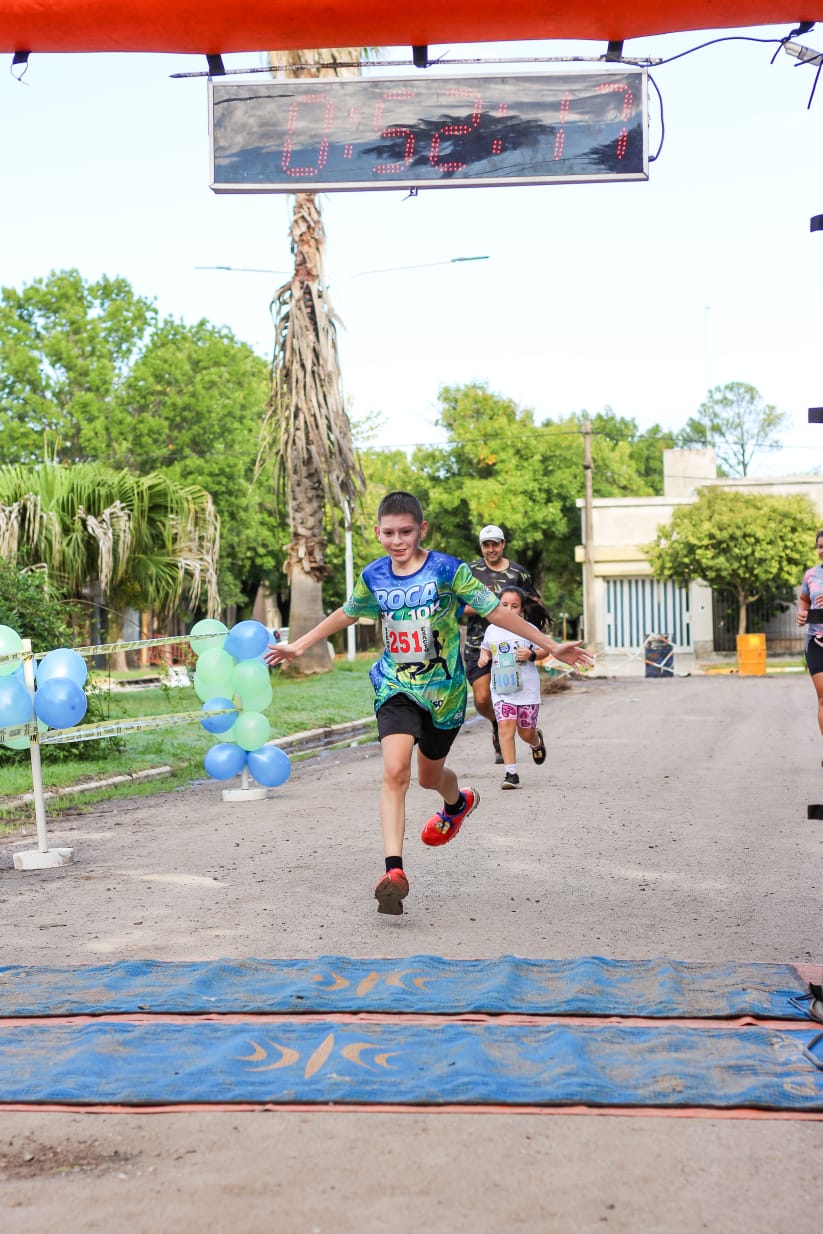 Ticiano Benavidez crosses the finish line during a running event in Argentina. The young runner from Santa Fe celebrates as he completes the race, showcasing the determination and passion that led him to become the Dare to Dream Argentina winner.